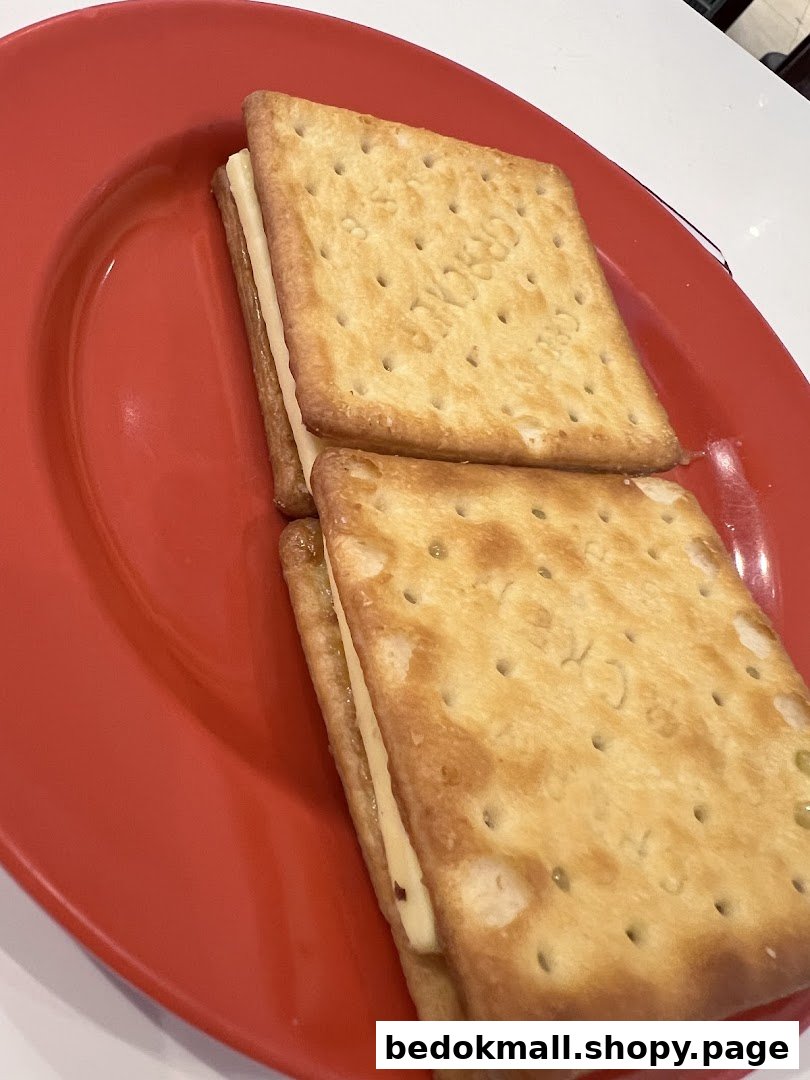 Two crackers with filling on a red plate.