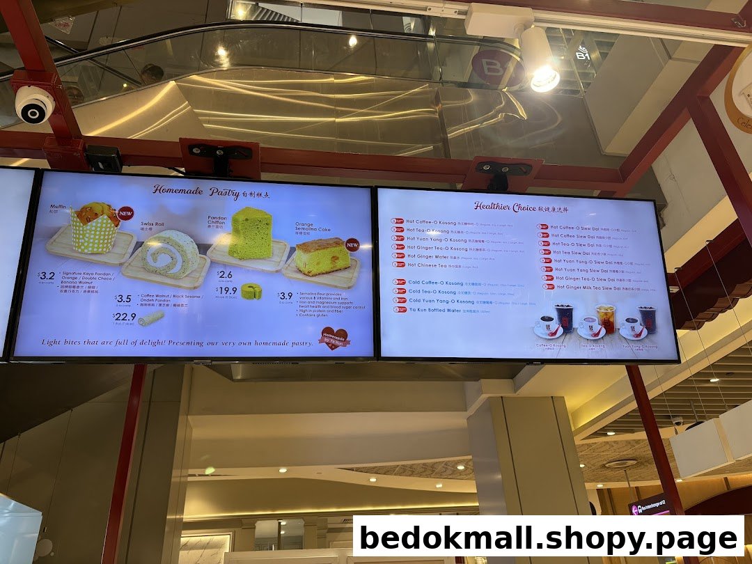 Digital screens displaying pastries, drinks, and prices at Ya Kun Kaya Toast.
