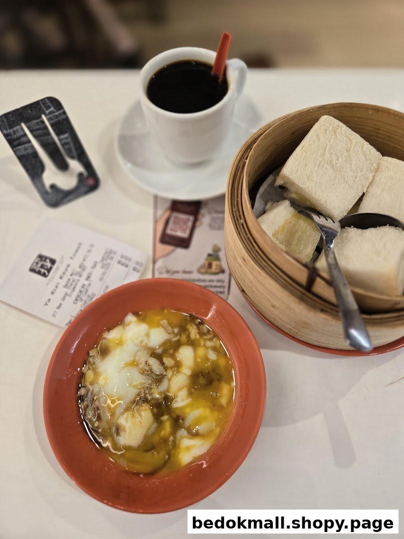 Coffee, soft-boiled eggs, and kaya toast served on a table.