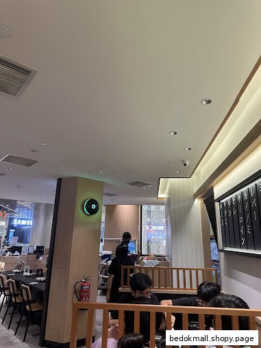 Interior view of a restaurant with diners and staff.