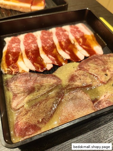 Tray of sliced raw beef and marinated tongue.
