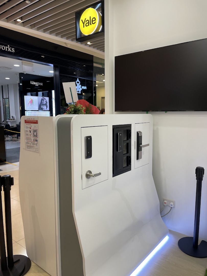 An interior display stand showcasing Yale smart locks with a brand sign overhead.