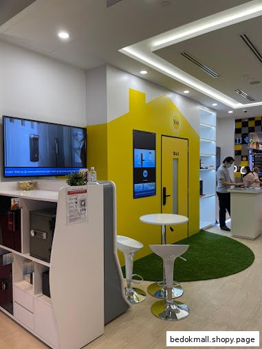 Interior view of a Yale Smart Shop with product displays and a house-shaped exhibit.