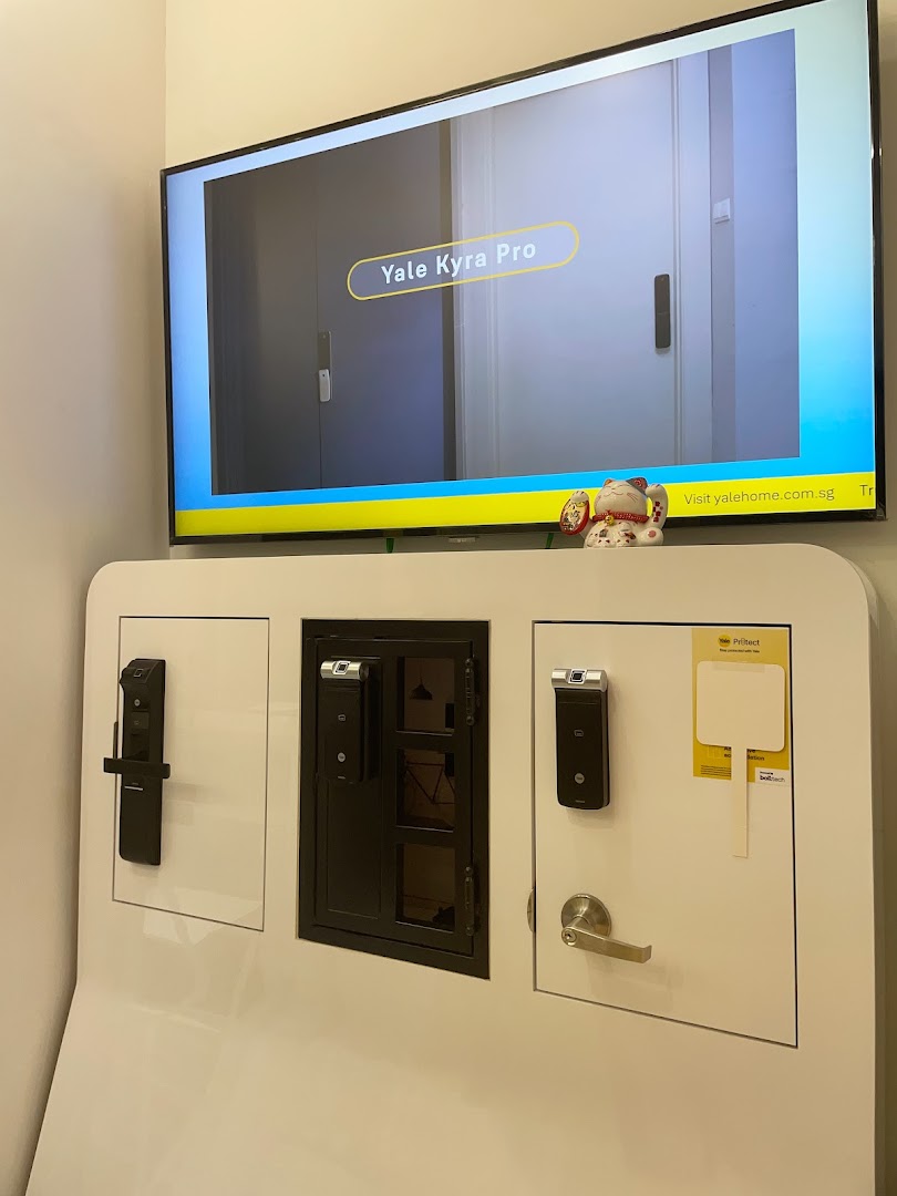 Interior display of Yale smart locks with a product video playing on a screen.
