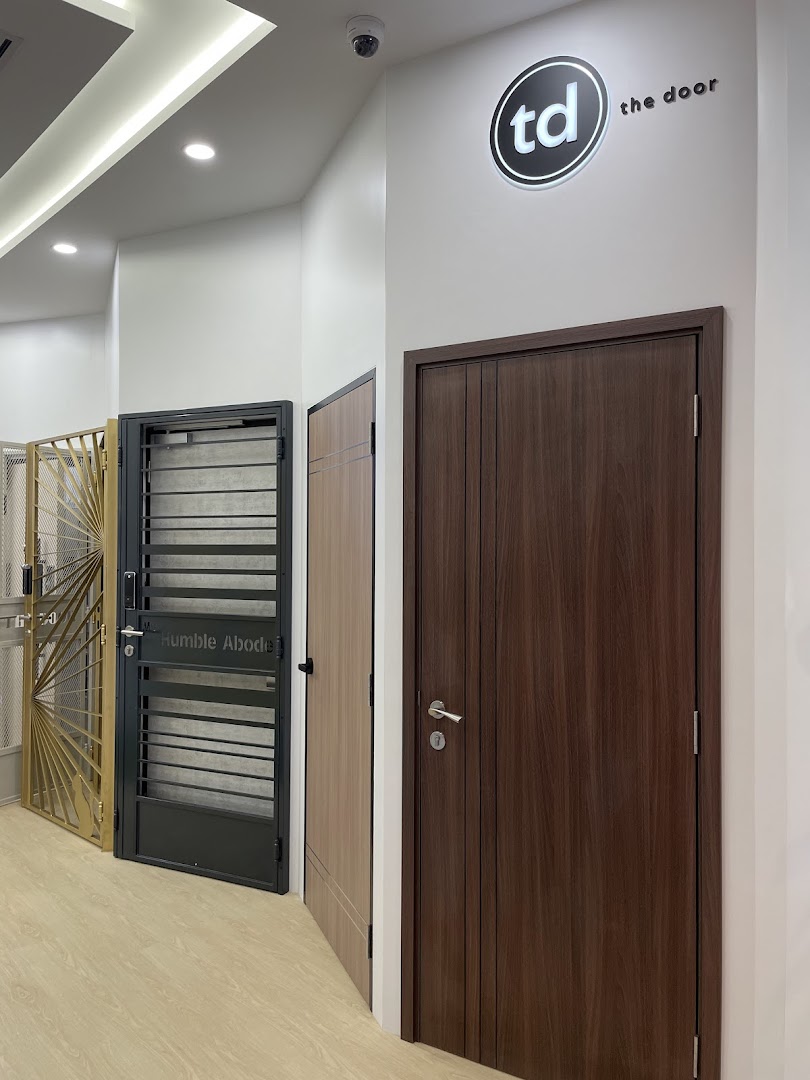 Interior view of a showroom displaying various doors and gates.