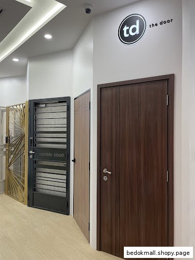 Interior view of a showroom displaying various doors and gates.