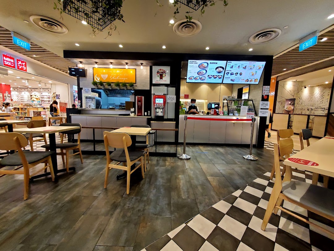 Interior view of a food court restaurant with seating and service counter.