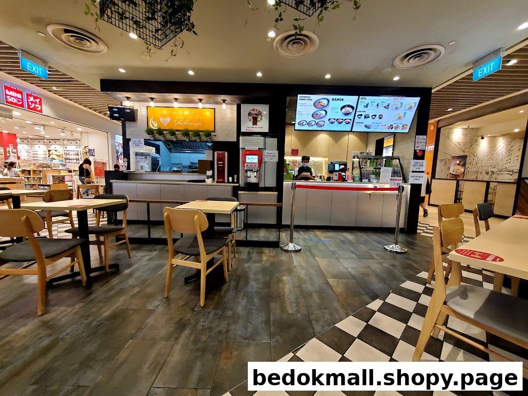 Interior view of a food court restaurant with seating and service counter.
