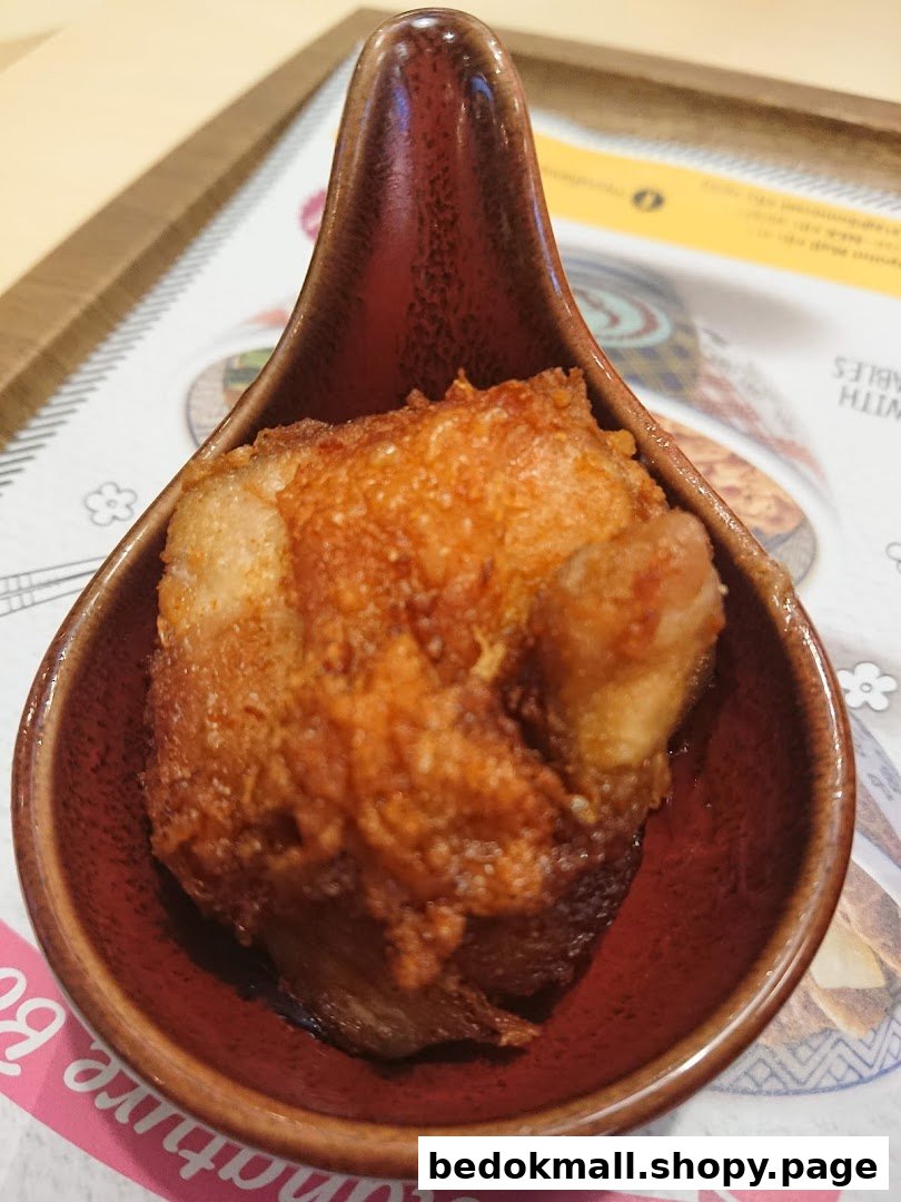 A close-up of a fried food item in a small brown dish.
