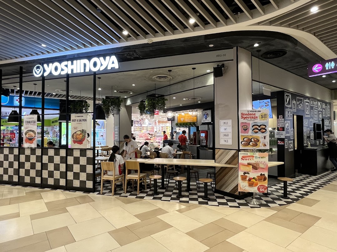 Yoshinoya restaurant storefront with signage and visible interior in a mall.