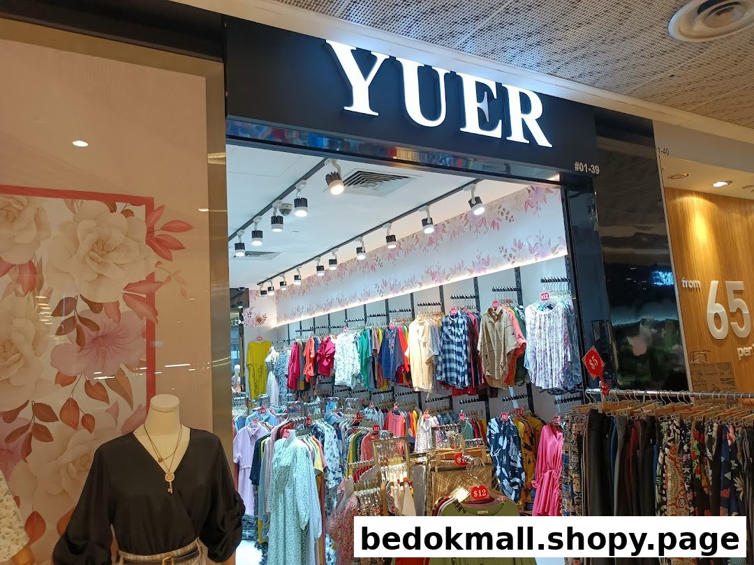 Shop entrance with visible signboard and clothing displays.
