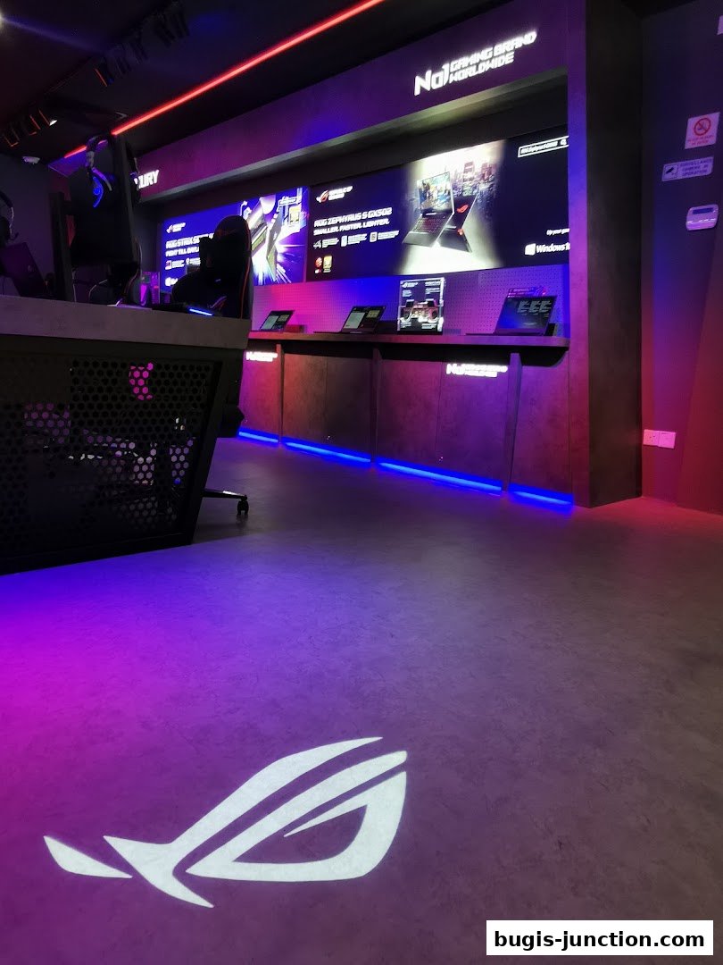 Interior of a ROG Experience Store with gaming setups and product displays.