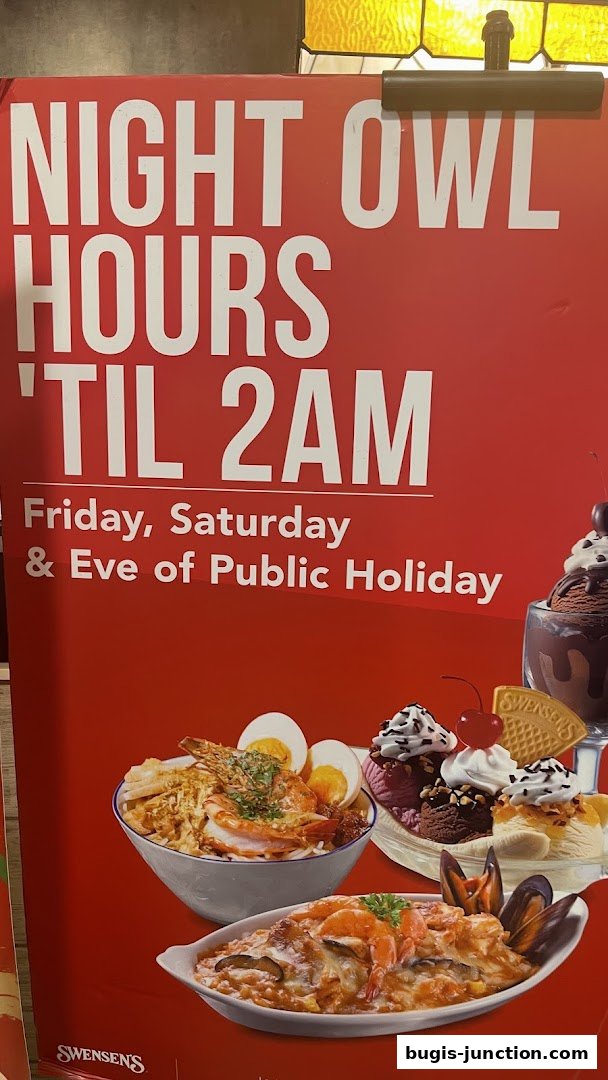 A red sign advertising Swensen's night owl hours until 2 AM on Fridays, Saturdays, and eves of public holidays.