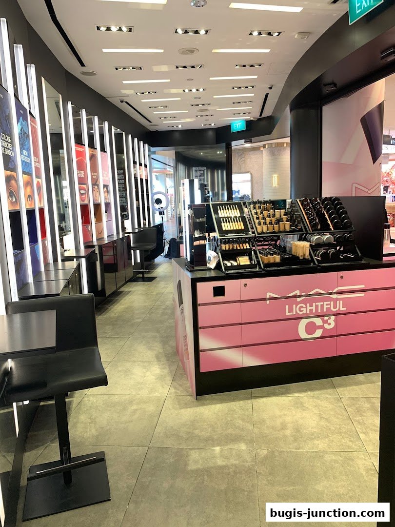 Interior view of a MAC Cosmetics store showcasing makeup displays and seating.