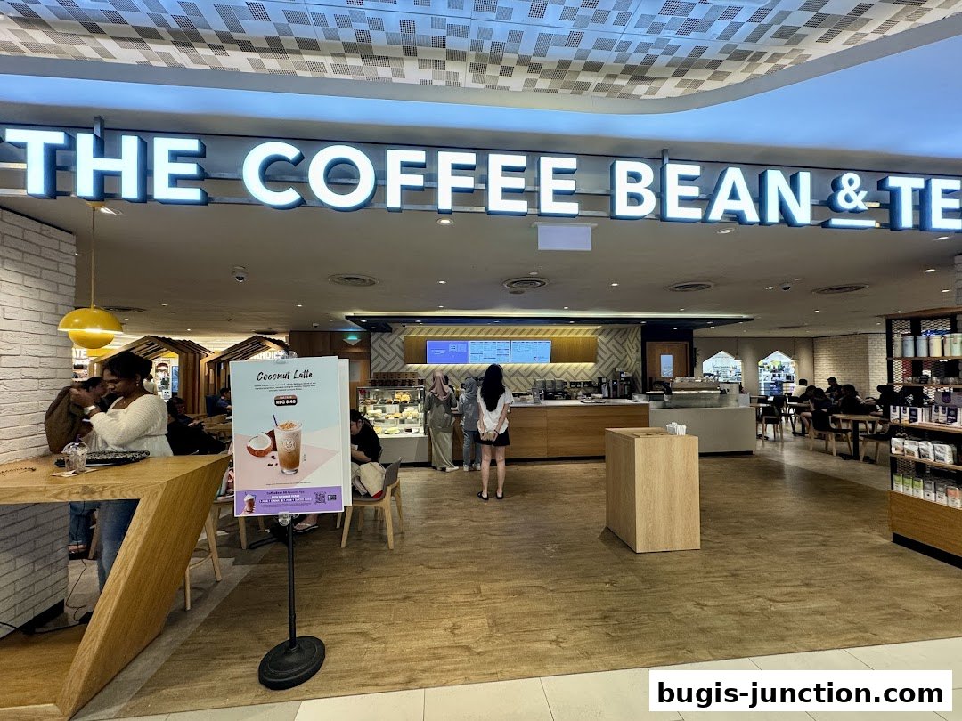 The Coffee Bean & Tea Leaf shop interior with customers and a promotional sign.