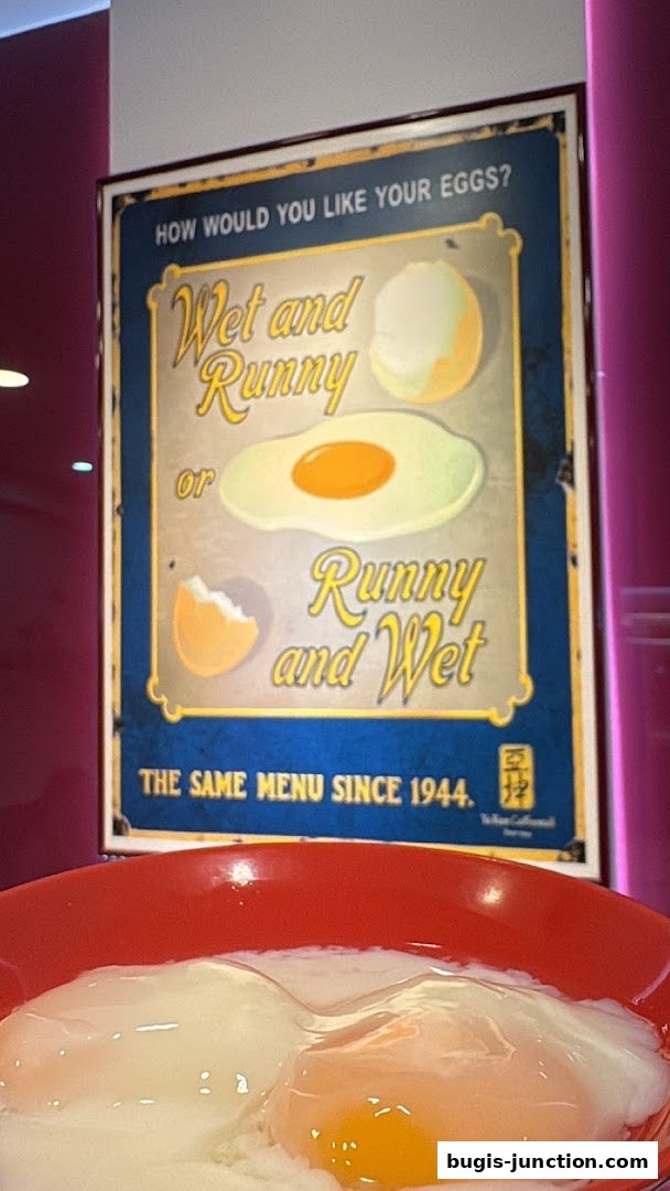 A sign about how to have eggs, with a bowl of soft-boiled eggs in the foreground.