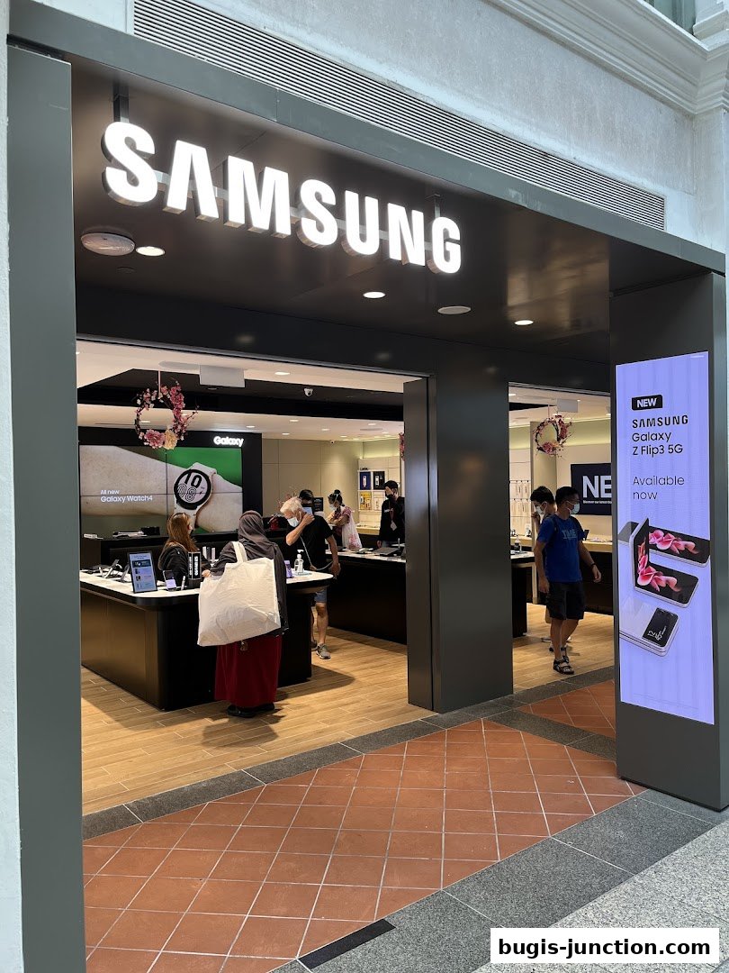 The entrance to a modern Samsung Experience Store with illuminated signage and product displays.