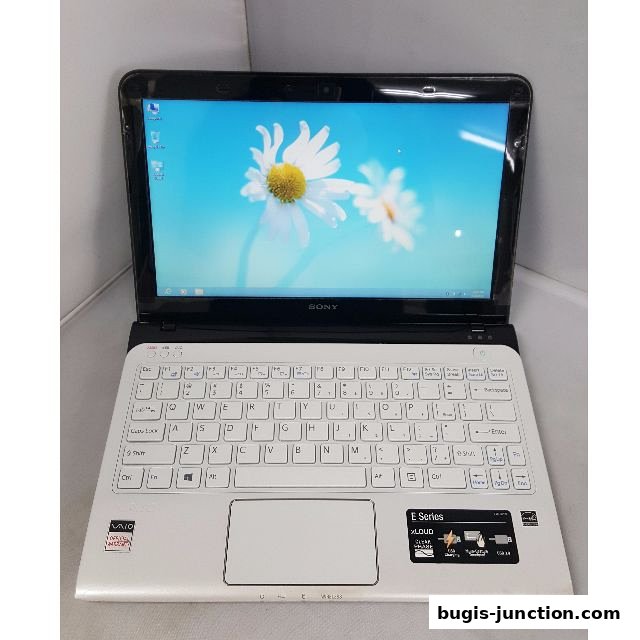 A white Sony VAIO E Series laptop with a floral wallpaper on the screen.