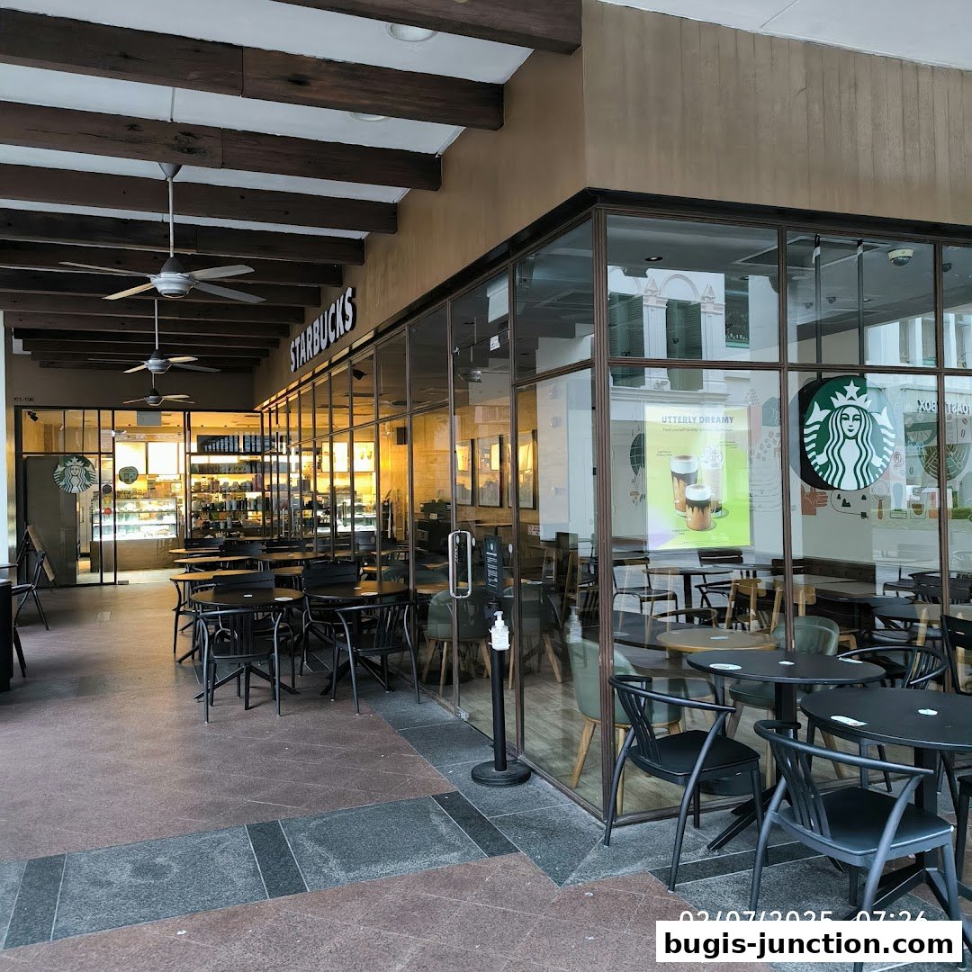 Exterior view of a Starbucks cafe with seating inside and outside.