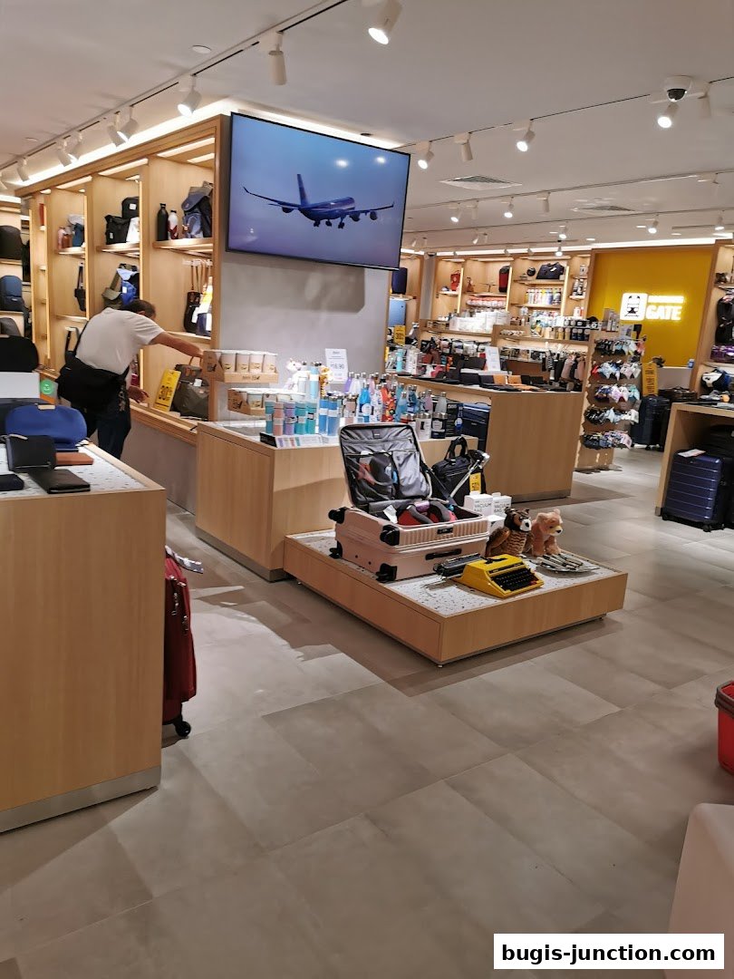 Interior of a travel goods store with luggage, bags, and accessories on display.