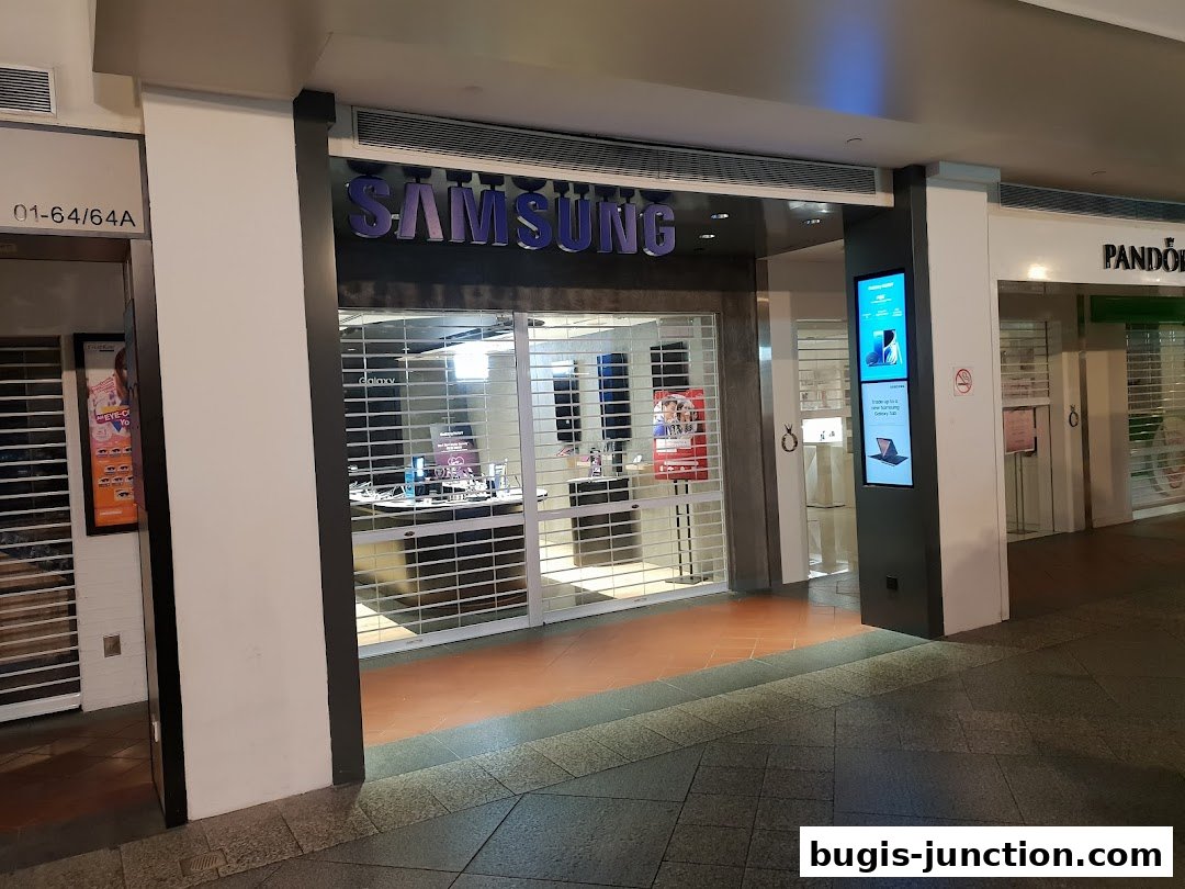 The Samsung Experience Store entrance with rolling shutters down, displaying Samsung products inside.