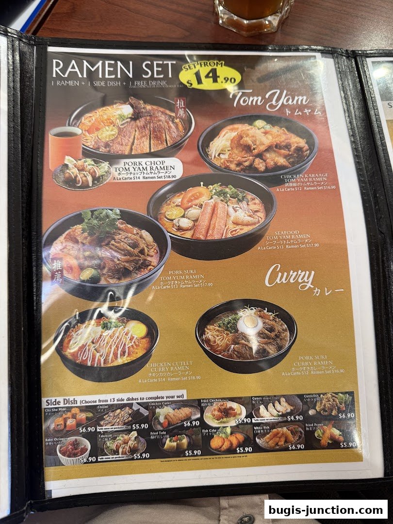 A menu featuring various ramen sets, including Tom Yam and Curry flavors, with side dish options.