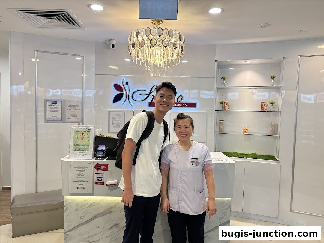 A man and a woman stand at the reception desk of a wellness center.