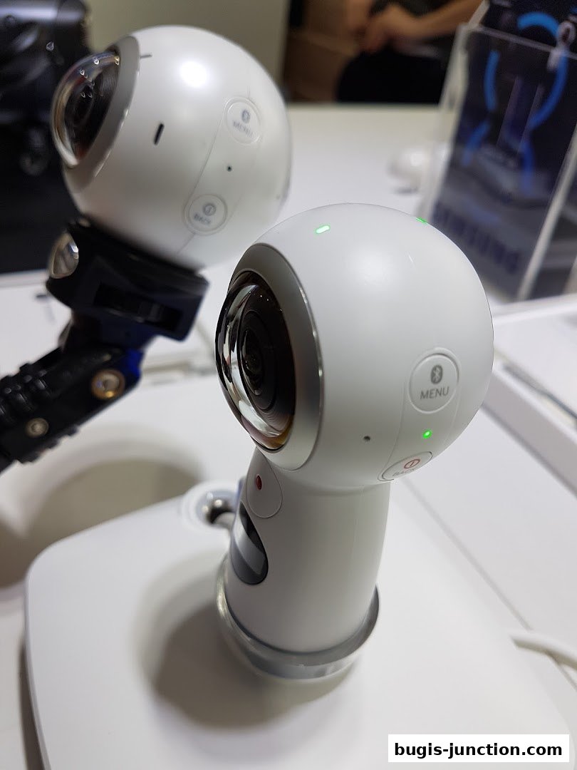 Close-up of two white Samsung 360-degree cameras on display stands.