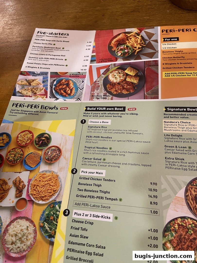 A menu from Nandos featuring fire-starters, PERi-PERi bowls, and signature bowls with various chicken options.