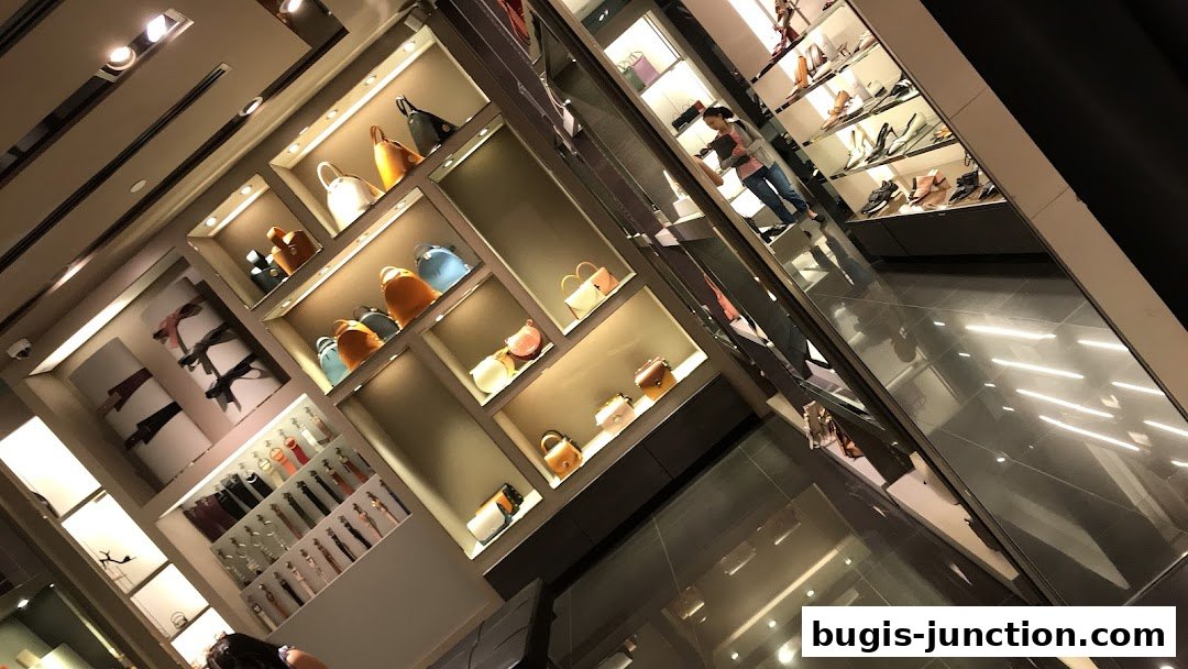 Interior view of a Charles & Keith store showcasing handbags and accessories on illuminated shelves.
