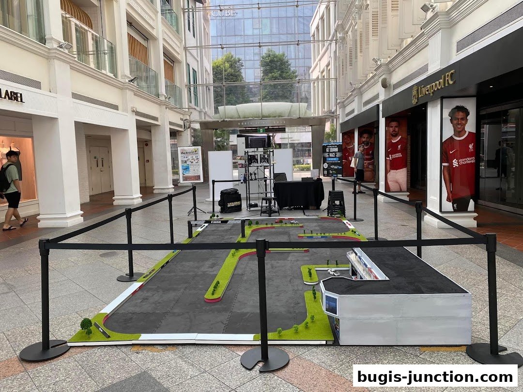 A miniature race track setup with a Liverpool FC store in the background.