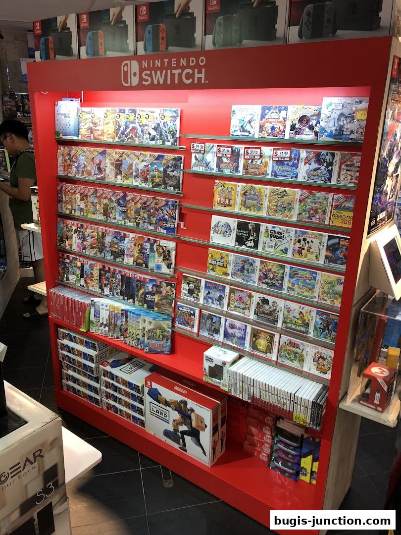 A display rack filled with Nintendo Switch games and accessories, with a customer browsing.