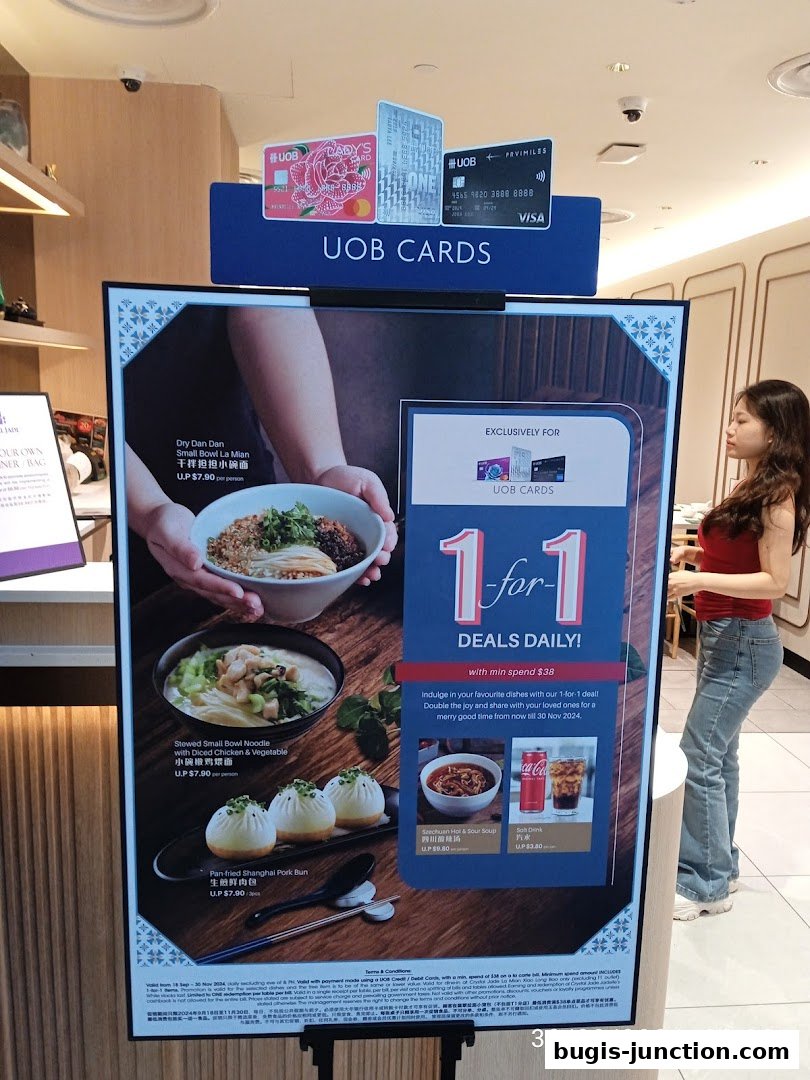 A promotional poster for Crystal Jade La Mian Xiao Long Bao featuring a 1-for-1 deal with UOB cards.