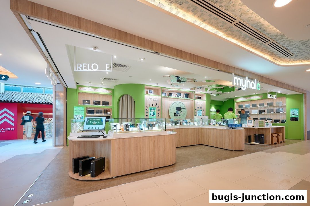 The brightly lit interior of a modern electronics store with a focus on laptops and upcycling.