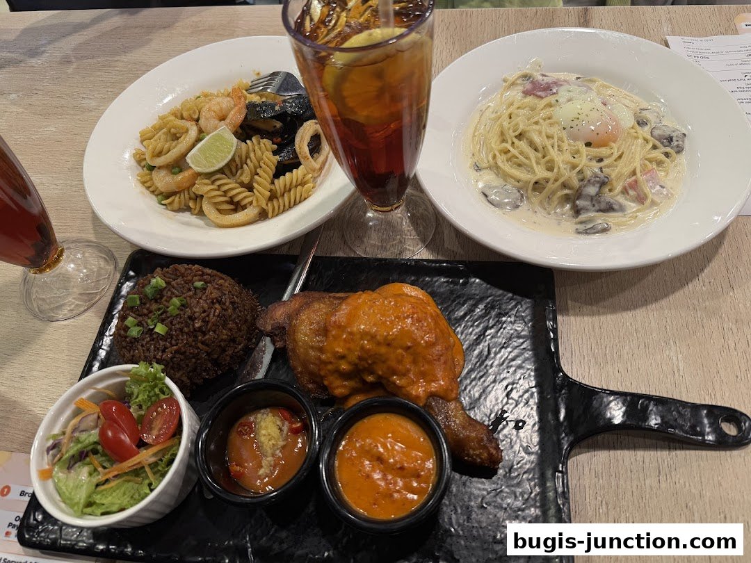 A table laden with delicious meals including pasta, chicken, rice, and drinks.