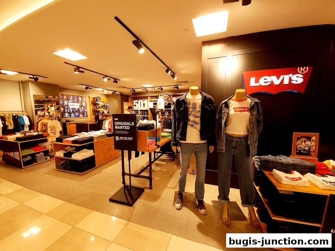 Interior of a Levi's store with mannequins showcasing denim outfits and clothing displays.