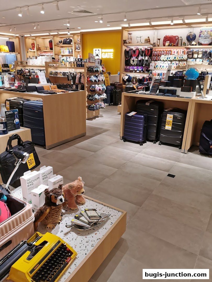 Interior view of a retail store selling luggage, travel accessories, and novelty items.