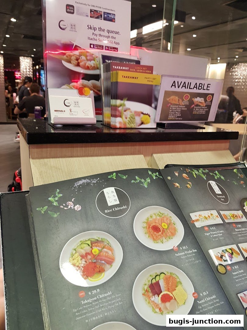 A close-up of an open sushi menu featuring various chirashi bowls and other dishes.