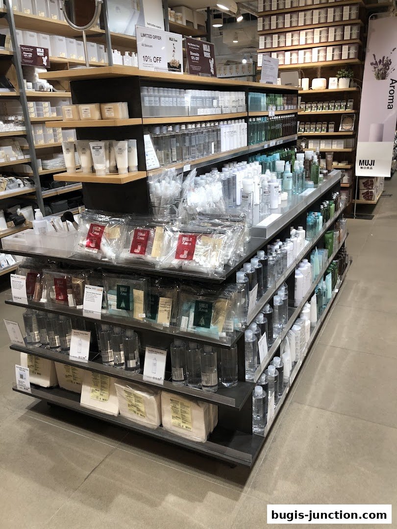 Interior view of a MUJI store showcasing skincare products and other household items on shelves.