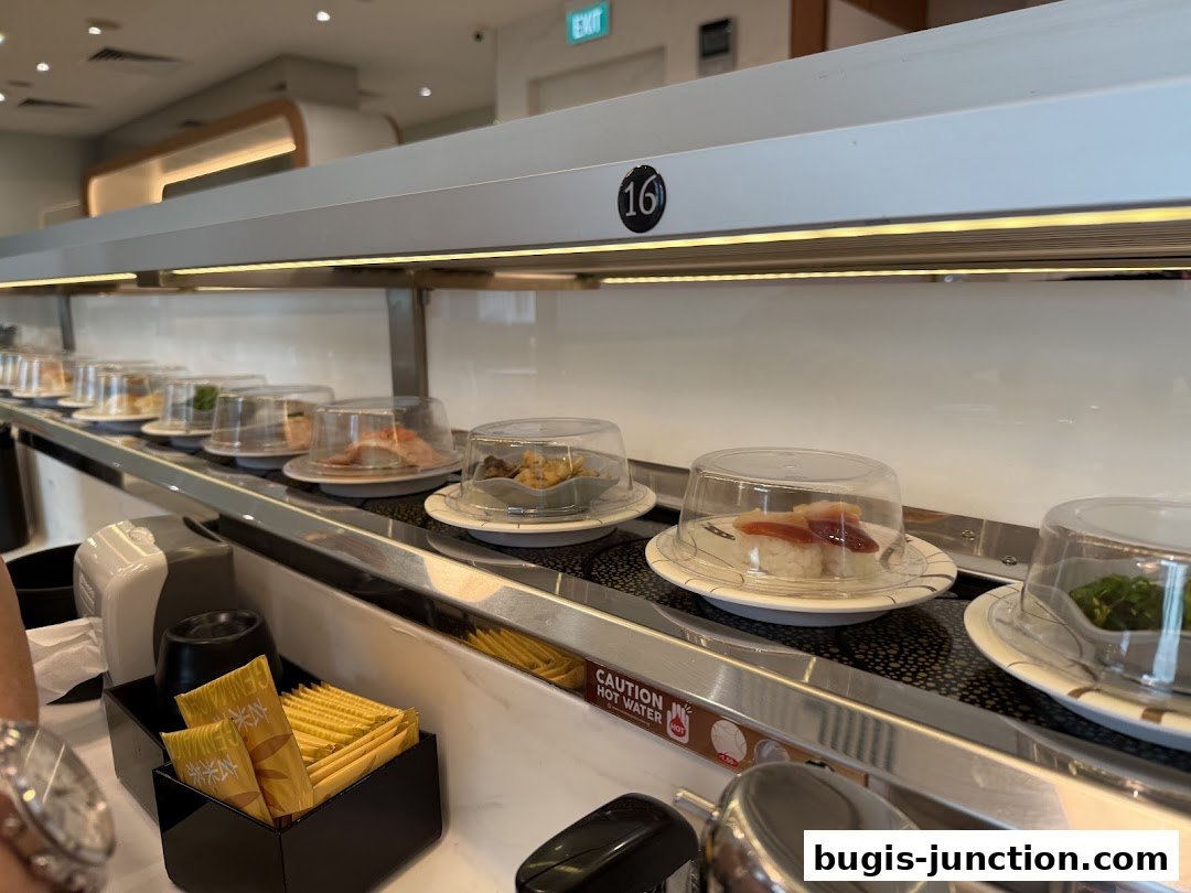 Sushi dishes on a conveyor belt at Sushi Plus, Bugis Junction.