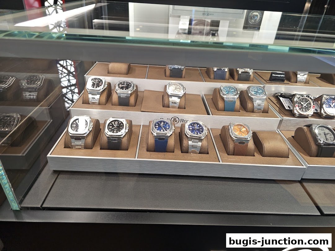 A display case filled with various luxury watches on stands.