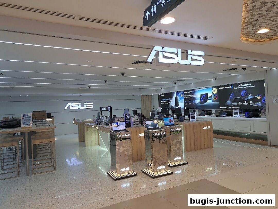 Interior view of an ASUS Exclusive Store showcasing laptops and technology.