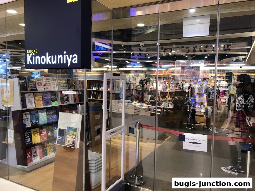 The entrance of Books Kinokuniya Bugis Junction, showcasing a wide selection of books and a modern store design.