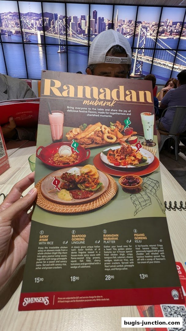 A person holds a Swensen's Ramadan Mubarak menu featuring four festive meal options.