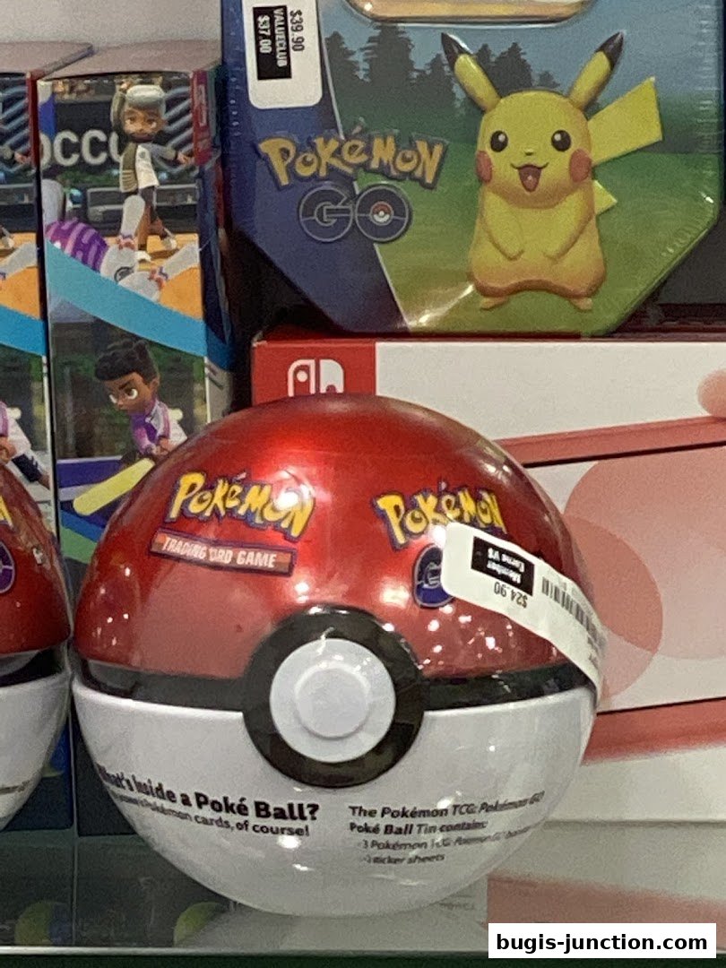 A close-up of Pokémon merchandise, including a Poké Ball and a Pikachu tin.