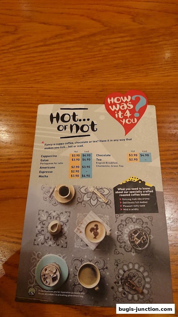 A menu displaying hot and iced coffee, chocolate, and tea options with prices.