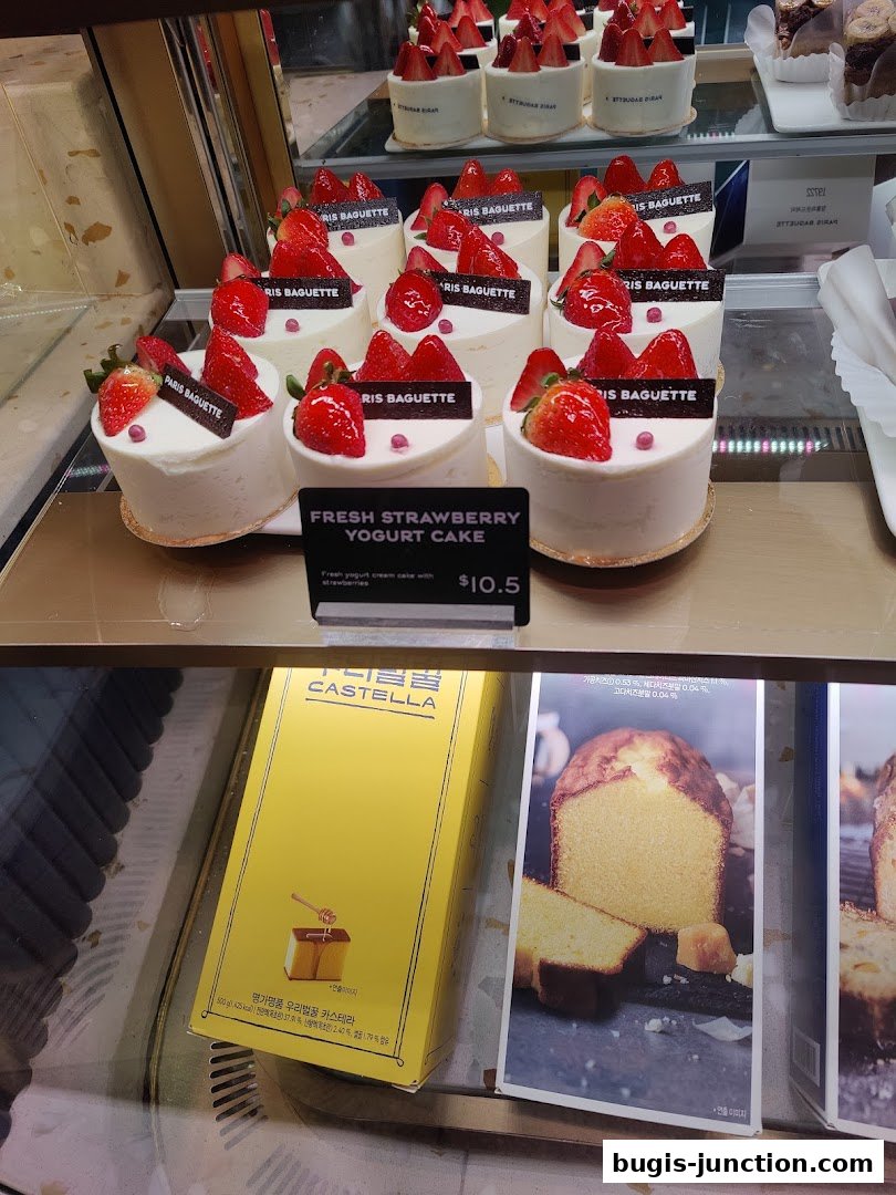 A display of fresh strawberry yogurt cakes and a box of Castella cake.