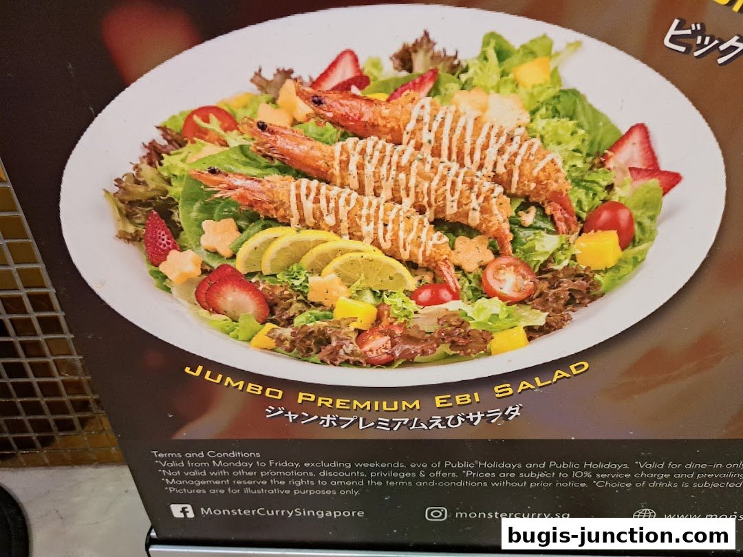 A close-up of a Jumbo Premium Ebi Salad with fried shrimp, strawberries, mango, and lemon.