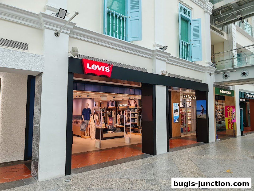 The exterior of a Levi's store with its iconic red logo and display windows.