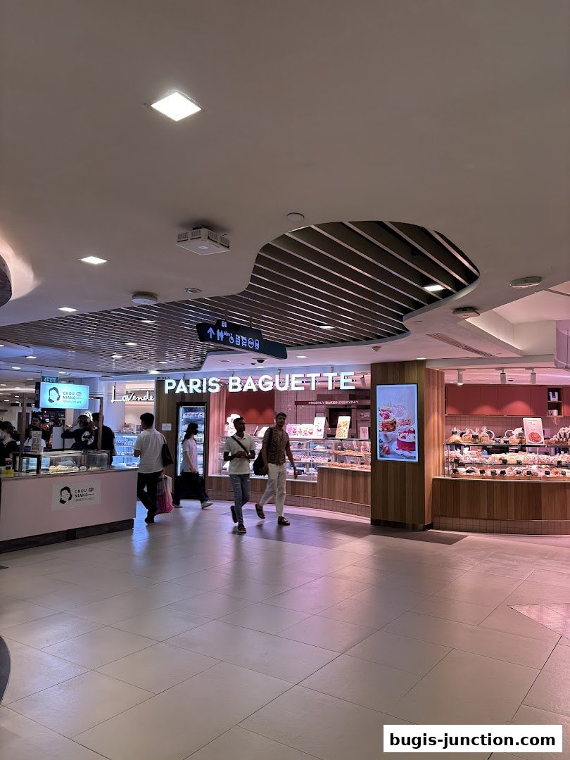 Paris Baguette shop front with display cases filled with pastries and bread.